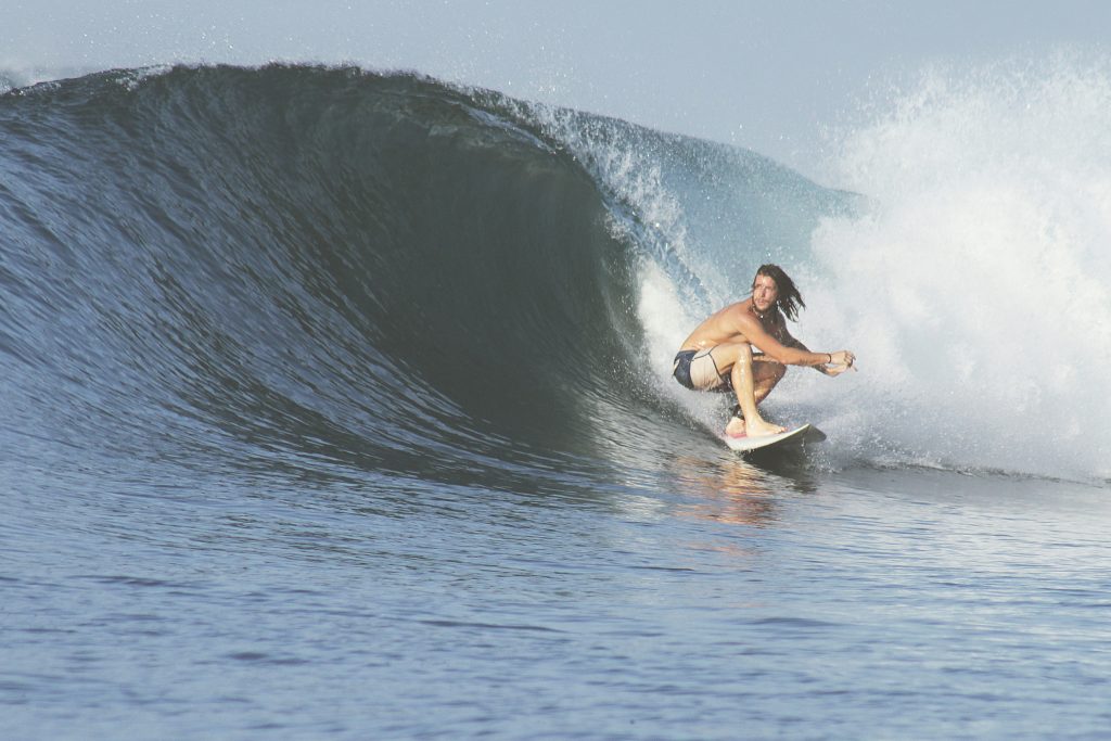 man surfing breaking waves